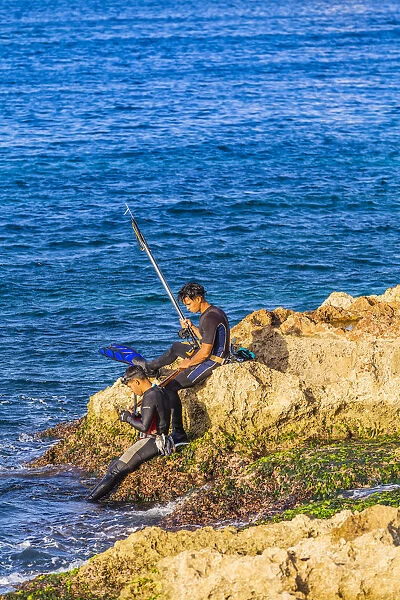 People spear fishing in the ocean off the Malecon For sale as