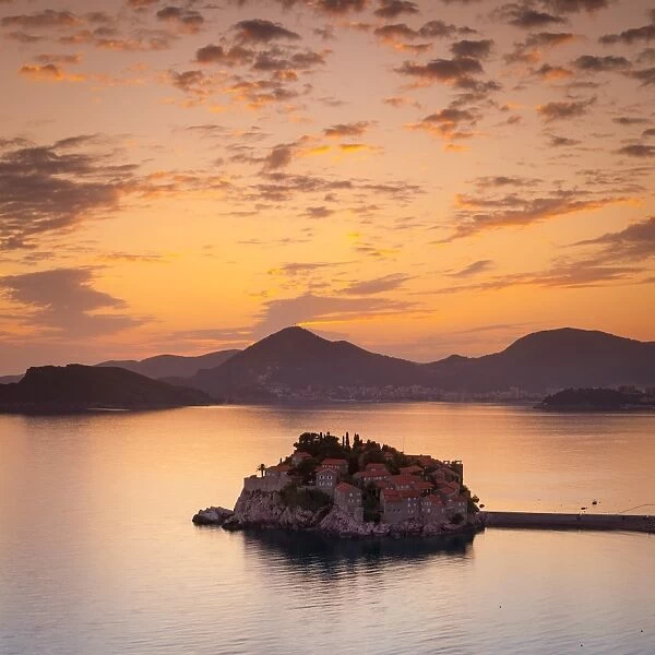 The picturesque island village of Sveti Stephan illuminated at sunset, Sveti Stephan