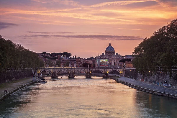 A romantic sunset on Tiber River with bridge Umberto I and Basilica di San Pietro