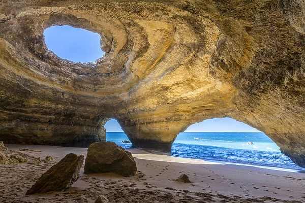 The sea caves of Benagil with natural windows on the clear waters of the Atlantic