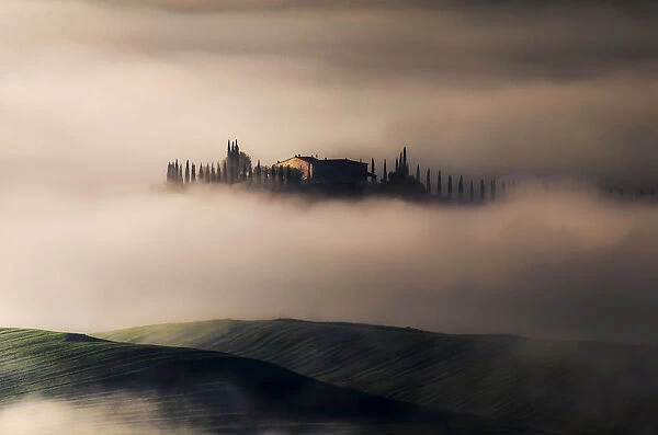 Siena countryside covered with fog during spring, Val d Orcia, Tuscany, Italy