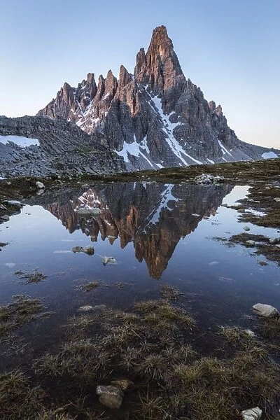 Sunrise of Mount Paterno reflected in a puddle, Natural Park Three Peaks, Sesto Pusteria