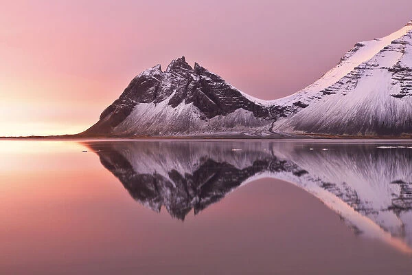 The Vestrahorn reflected in the bay during a winter sunrise, Austurland, Southern Iceland