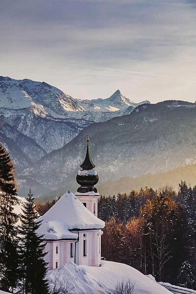 View of the church of Wallfahrtskirche Maria Gerna at sunset in winter sorrounded