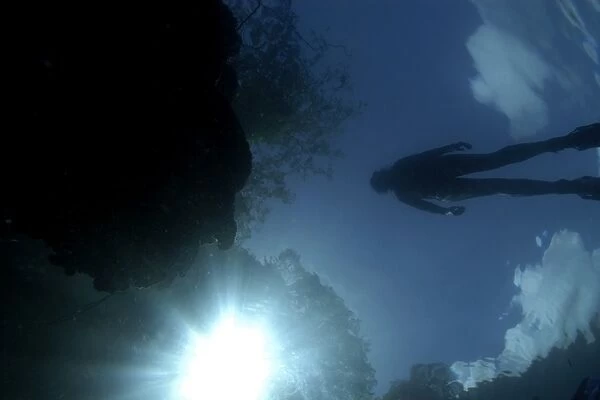 Diver silhouette on Rock Island lagoon, Palau, Micronesia