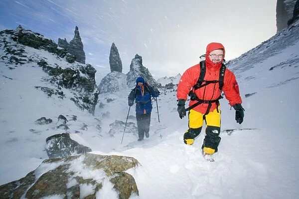 Hikers in a blizzard near the Old Man of Storr on the isle of Skye Scotland