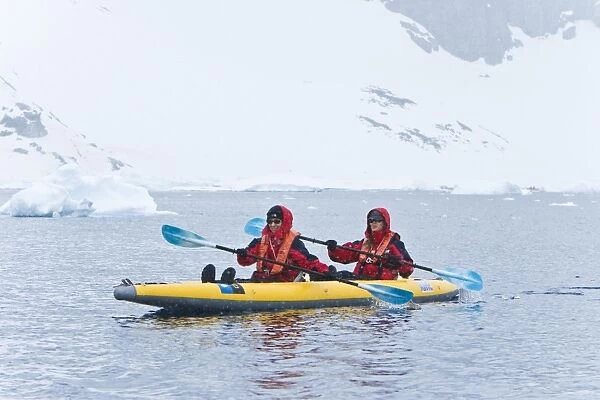 Lindblad Expeditions guests kayaking in snowstorm in Antarctica as part of expedition travel. NO MODEL RELEASES FOR THIS IMAGE