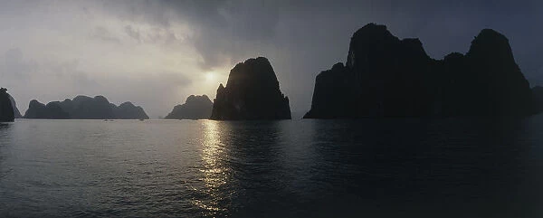 20014984. VIETNAM North Ha Long Bay Sunset behind the silhouetted islands