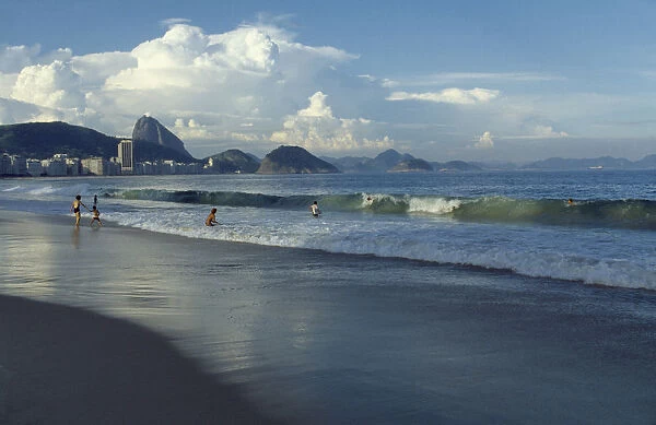 20066229. BRAZI Rio de Janeiro Beach with people playing in the surf