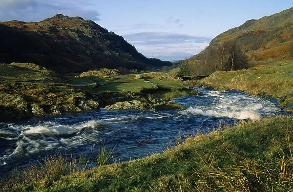England, Cumbria, Lake District, Watendlath Beck. Fast flowing river running inbetween hills