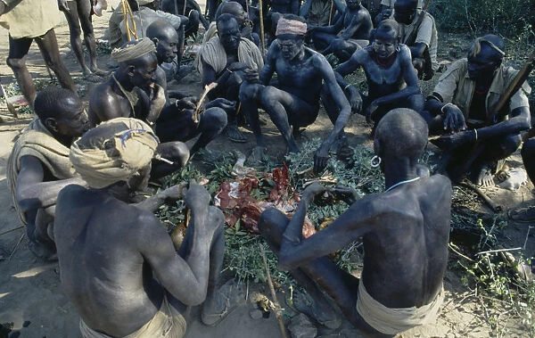 Ethiopia, General, Mursi tribesmen feasting after Nitha Age Set Ceremony