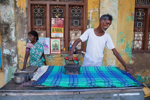 India, Pondicherry, Man ironing linen in Pondicherry