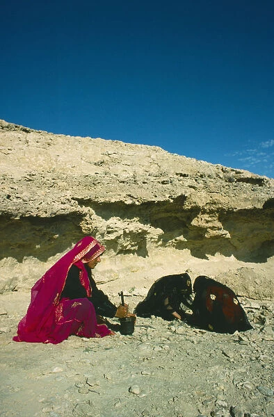 Qatar, General, Bedouin women grinding wild herbs using a pestle and mortar