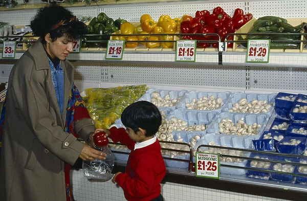Shopping, Supermarkets, Interior, Woman with her young son shopping for vegetables