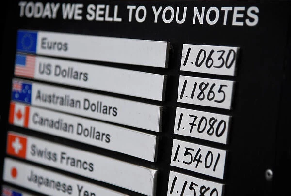 A board displaying buying and selling rates is seen outside of a currency exchange outlet