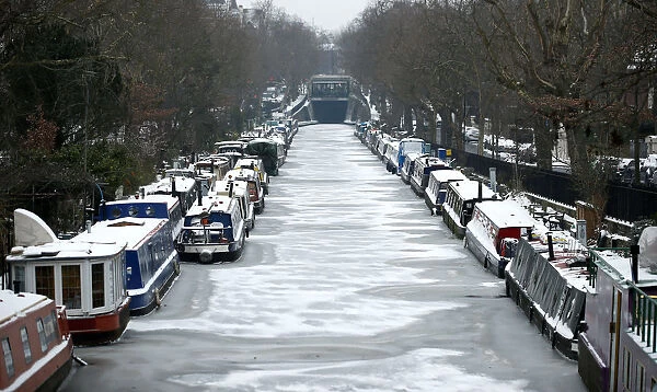 Canal boats are frozen at their berths on the Regents Canal in Maida Vale in London