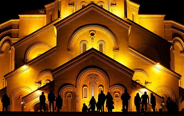 People walk in front of the Holy Trinity cathedral a midnight Christmas service in