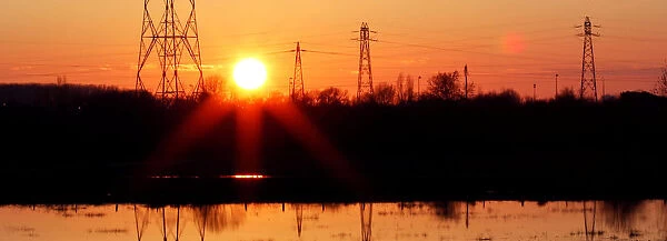 Pylons of high-tension electricity power lines are seen during sunset in Bordeaux