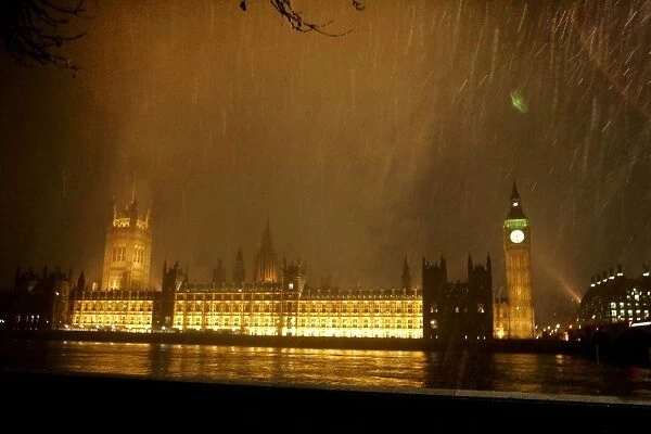Snow falls over the Houses of Parliament in London