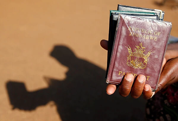 A street vendor offers passport covers for sale outside a Home Affairs Department office