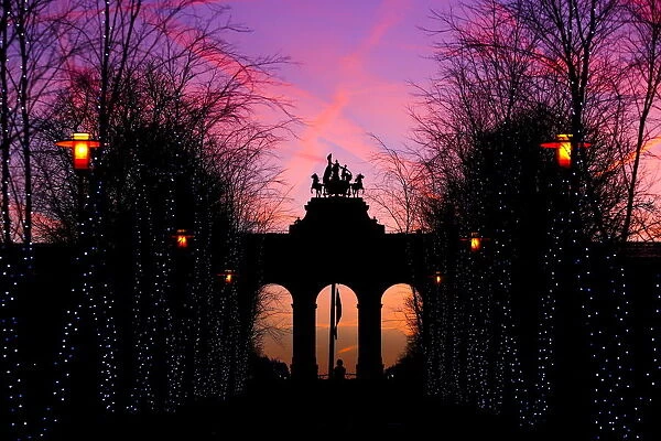 The sun rises behind the Cinquantenaire arch in Brussels