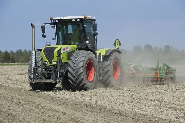 Cls Xerion 3300 TRAC VC tractor with Amazone Catros 5501-T disc harrows, harrowing arable field, Sweden, may