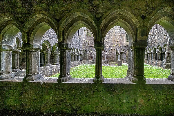 Ancient cloisters surround this patch of grass at Moyne Abbey, County Mayo, Ireland