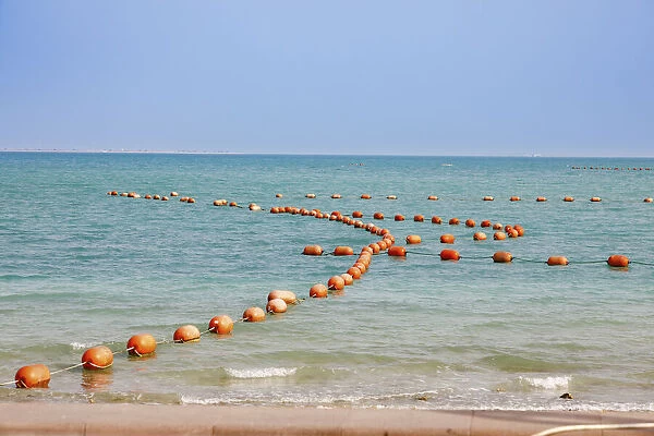 Arabian Peninsula, Persian Gulf, State of Qatar, Doha. Orange buoys in bay