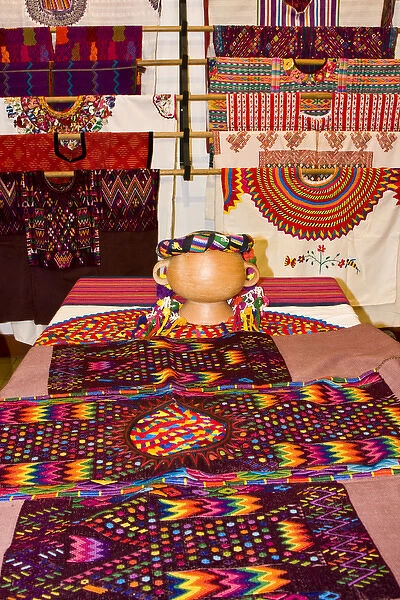 Central America, Guatemala, Antigua. A display of colorful huipils in a shop in Antigua