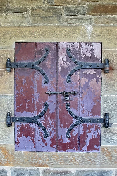 Doors with wrought iron hinges are found in an outdoor passageway at Cardiff Castle
