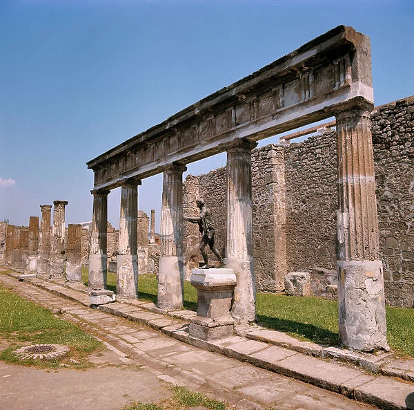 Europe, Italy, Pompeii. A bronze reproduction of Greek god Apollo stands at the Temple