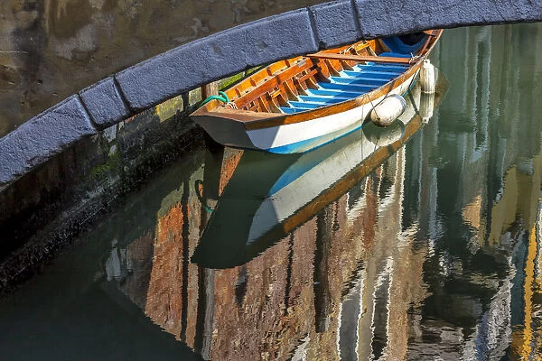 Europe, Italy, Venice. Boat underneath bridge