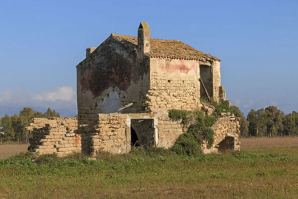 Italy, Central, Southeastern Italy. Ruins of a stone farmhouse in fields