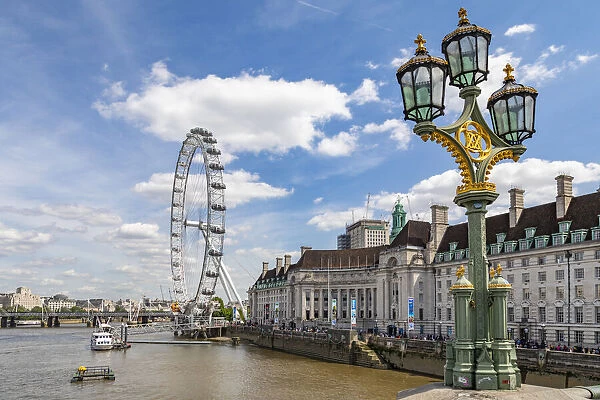 The London Eye and iconic British lamppost in London, England