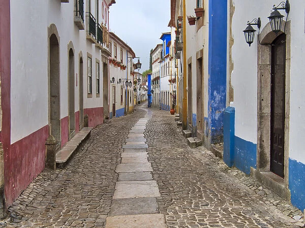 Portugal, Obidos. View looking down the main shopping street