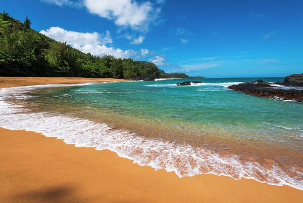 Sand and surf at Lumahai Beach, Island of Kauai, Hawaii USA