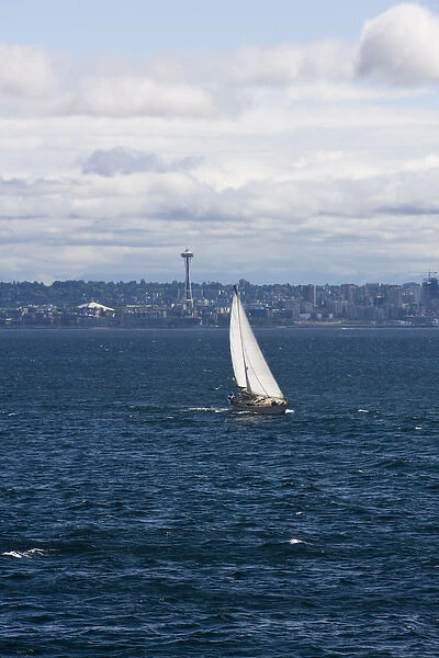A small sailboat is propelled by a strong burst of wind off the coast of Seattle