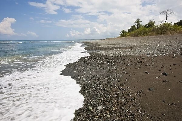 Surf rolls in on a pristine tropical beach with in Corcovado National Park, Costa Rica