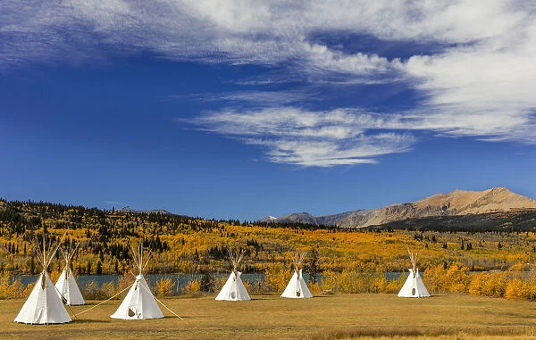 Tipis with Yellow Mountain in background at Chewing Black Bones campground near St Mary