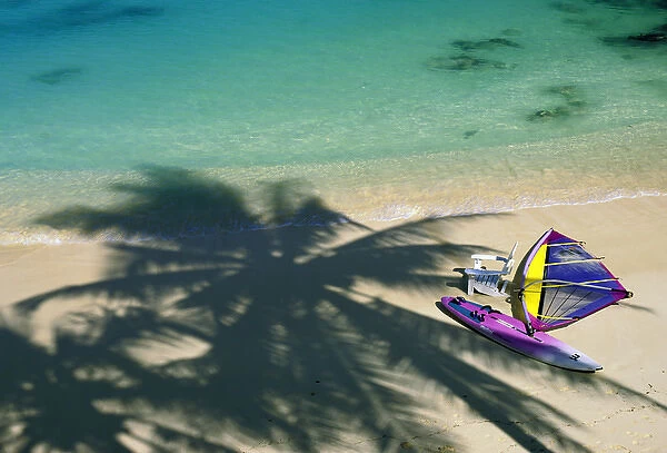USA, Hawaii. Chair and windsurfer on beach