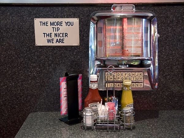 USA, Illinois, Chicago. Old-time tableside jukebox and humorous sign at a nostalgic diner