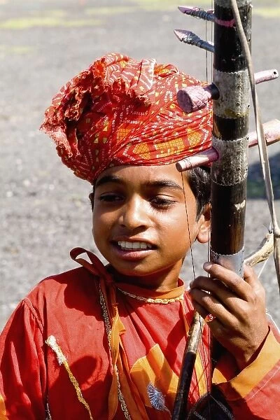 Young boy aged 10 with musical instrument called Sarangi on road to Jodhpur in Rajasthan India