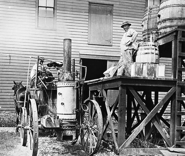 AMERICA FARMING, c1915. An early steam-engine sprayer used to apply pesticides, c1915
