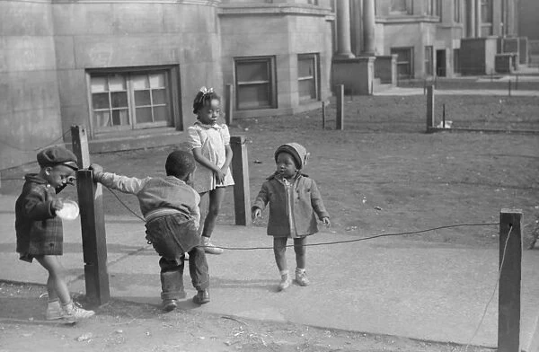 CHICAGO: CHILDREN, 1941. Children playing in front of an apartment building
