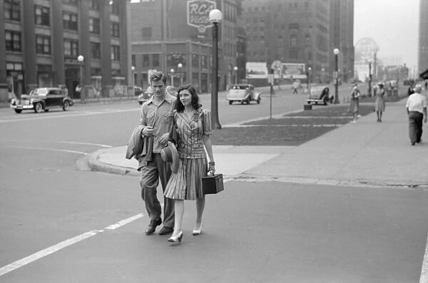 CHICAGO: MICHIGAN AVENUE. A couple crossing Michigan Avenue in Chicago, Illinois