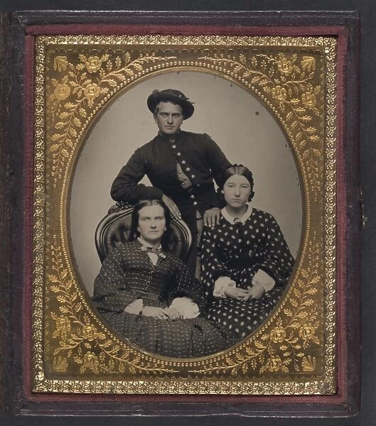 CIVIL WAR: SOLDIER, c1863. Portrait of a Union soldier and two women. Tintype, c1863