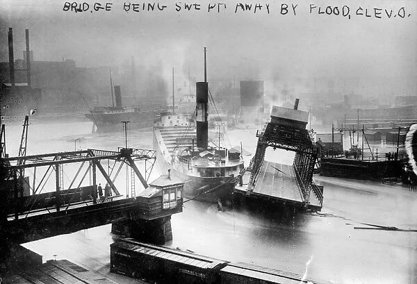 CLEVELAND: FLOOD, c1913. A bridge being swept away during a flood in Cleveland, Ohio