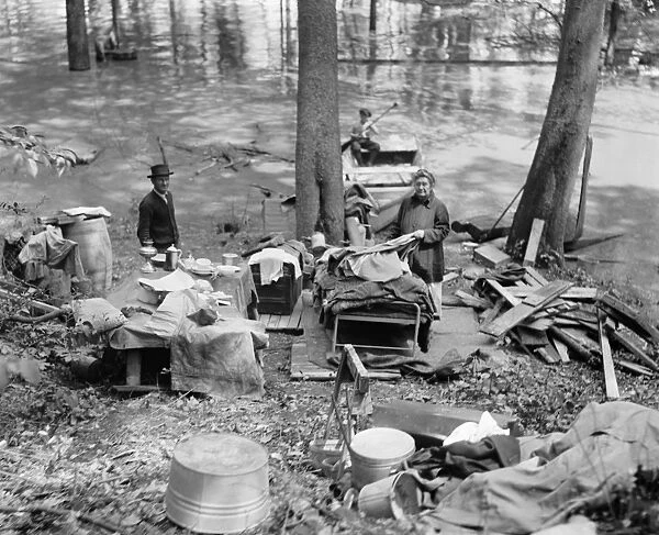 FLOOD, 1924. Flood refugees with their salvaged possessions. Photograph, 1924