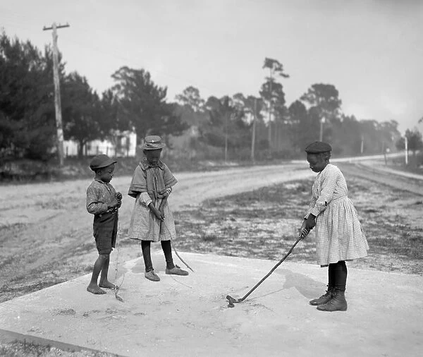 GOLFING, c1905. Children playing golf. Photograph, c1905