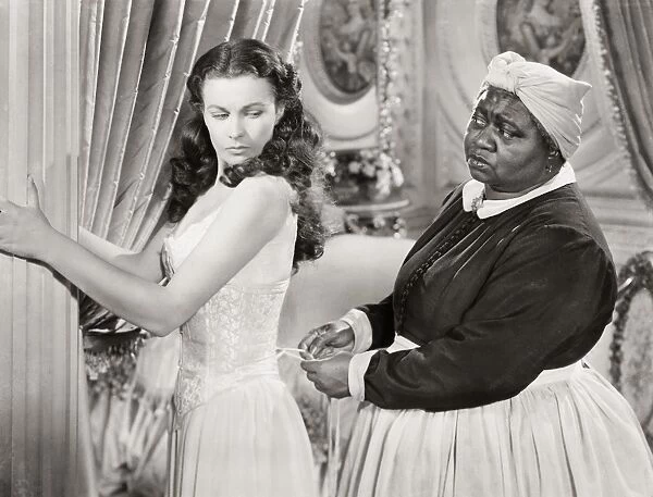 GONE WITH THE WIND, 1939. Hattie McDaniel assists Vivien Leigh while offering some unwelcomed advice